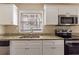 Updated kitchen with granite countertops and stainless steel appliances at 2473 Tyler Way, Decatur, GA 30032