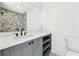 Modern bathroom with gray vanity and tiled shower at 10861 Serenbe Ln, Chattahoochee Hills, GA 30268