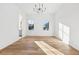 Bright bedroom with hardwood floors and a chandelier at 10861 Serenbe Ln, Chattahoochee Hills, GA 30268