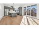 Modern kitchen with gray cabinetry, island and breakfast area at 10861 Serenbe Ln, Chattahoochee Hills, GA 30268