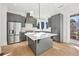 Modern kitchen with gray cabinets, stainless steel appliances, and an island at 10861 Serenbe Ln, Chattahoochee Hills, GA 30268