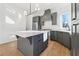 Modern kitchen with gray cabinets, stainless steel appliances, and an island at 10861 Serenbe Ln, Chattahoochee Hills, GA 30268