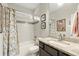 Clean bathroom with granite vanity, tiled shower, and floral shower curtain at 1159 Morley Se Ave, Atlanta, GA 30312