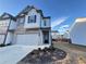 Two-story townhome with stone and white siding, two-car garage, and landscaping at 1394 Ben Park Way, Grayson, GA 30017