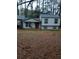 Gray siding home with a red front door and mature trees at 3195 Newcastle Way, Snellville, GA 30039