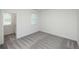 Bright bedroom with gray carpet, window and access to a small room at 705 Dodd N Ln # 163, Buford, GA 30518