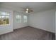 Bright bedroom with carpet, ceiling fan, and two windows at 705 Dodd N Ln # 163, Buford, GA 30518