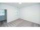 Bright bedroom with gray carpet, window and access to a small room at 705 Dodd N Ln # 163, Buford, GA 30518