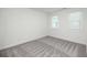 Bright bedroom featuring grey carpet and two windows at 705 Dodd N Ln # 163, Buford, GA 30518