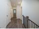 Upstairs hallway with gray flooring and access to bedrooms at 705 Dodd N Ln # 163, Buford, GA 30518