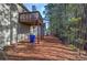 Home features a deck, fenced backyard, and wooded area at 113 Omega Ct, Dallas, GA 30157