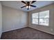 Bedroom with ceiling fan, window, and neutral colored carpet at 113 Omega Ct, Dallas, GA 30157