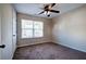 Simple bedroom with neutral walls, ceiling fan, and brown carpet at 113 Omega Ct, Dallas, GA 30157