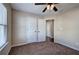 Spacious bedroom with carpet flooring, ceiling fan, and ample closet space at 113 Omega Ct, Dallas, GA 30157