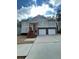 Two-story house with a two-car garage and a red wooden staircase at 113 Omega Ct, Dallas, GA 30157