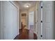 Clean hallway with dark hardwood floors and access to bedrooms at 113 Omega Ct, Dallas, GA 30157