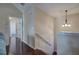 Upstairs hallway with hardwood floors and access to bedrooms at 113 Omega Ct, Dallas, GA 30157