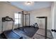 Home gym with treadmill, squat rack, and weights at 113 Omega Ct, Dallas, GA 30157