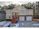 Two-story house with double garage and a covered front porch at 113 Omega Ct, Dallas, GA 30157