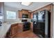 Modern kitchen with granite countertops, dark wood cabinets, and black appliances at 113 Omega Ct, Dallas, GA 30157