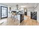 Modern kitchen with white cabinets, a large island, and black marble countertops at 1810 Kinridge Rd, Marietta, GA 30062