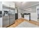 Stainless steel refrigerator in a modern kitchen with white cabinets and hardwood floors at 1810 Kinridge Rd, Marietta, GA 30062