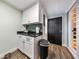 Small galley kitchen with white cabinets and dark countertop at 1810 Kinridge Rd, Marietta, GA 30062