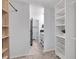 Walk-in closet with built-in shelves and a bathroom entrance at 23304 Plantation Ne Dr # 304, Atlanta, GA 30324