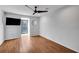 Spacious bedroom featuring wood floors, a window, and a wall-mounted TV at 23304 Plantation Ne Dr # 304, Atlanta, GA 30324