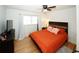 Main bedroom with large bed, TV and hardwood floors at 4924 River Rd, Ellenwood, GA 30294