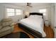 Relaxing bedroom featuring a comfortable chair and ceiling fan at 4924 River Rd, Ellenwood, GA 30294