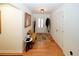 Bright entryway with bench, coat rack and hardwood floors at 4924 River Rd, Ellenwood, GA 30294