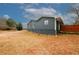 Side view of a renovated home with gray siding at 4924 River Rd, Ellenwood, GA 30294