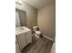 Small half bathroom with toilet and vanity at 5451 Zachary Dr, Stone Mountain, GA 30083