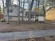 Two-story house with beige siding, a covered porch, and a two-car garage at 5451 Zachary Dr, Stone Mountain, GA 30083