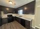 Kitchen with dark brown cabinets, black appliances, and marble countertops at 5451 Zachary Dr, Stone Mountain, GA 30083