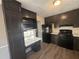 Kitchen with dark wood cabinets, black appliances, and a built-in desk at 5451 Zachary Dr, Stone Mountain, GA 30083