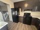 Black appliances and dark brown cabinets in this kitchen at 5451 Zachary Dr, Stone Mountain, GA 30083