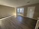 Living room with hardwood floors, bay window, and neutral walls at 5451 Zachary Dr, Stone Mountain, GA 30083