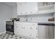 Modern kitchen with white cabinets, stainless steel appliances, and patterned floors at 1991 Judy Se Cir, Marietta, GA 30060