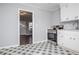 Renovated kitchen featuring white cabinets, stainless steel appliances, and a view of the living room at 1991 Judy Se Cir, Marietta, GA 30060