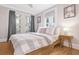 Cozy bedroom with light gray bedding and hardwood floors at 841 United Se Ave, Atlanta, GA 30312