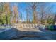 Small concrete deck with white railing and wooded view at 491 Elbridge Nw Dr, Atlanta, GA 30318