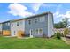Townhouse exterior with private patio and fenced yard at 1180 Chastain Dr # 9, Sugar Hill, GA 30518