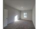 Spacious bedroom with carpet flooring and a window at 28 Loth Wages (Lot 28) Rd, Dacula, GA 30019