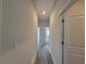 Long hallway with light walls and vinyl flooring at 28 Loth Wages (Lot 28) Rd, Dacula, GA 30019