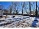 Large backyard with snow and tree stumps at 4593 Bexley Way, Stone Mountain, GA 30083