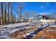 Large backyard with light snow cover and a partially visible house at 4593 Bexley Way, Stone Mountain, GA 30083