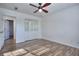 Bedroom with wood-look floors, mirrored closet doors, and ceiling fan at 4593 Bexley Way, Stone Mountain, GA 30083