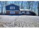 Brick and blue-sided house with a snow-covered yard at 4593 Bexley Way, Stone Mountain, GA 30083